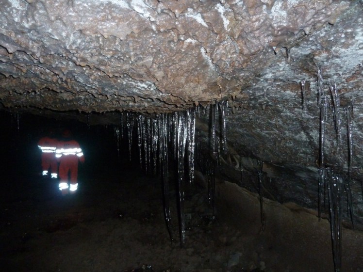 Long shiny icicles hanging from the cave roof
