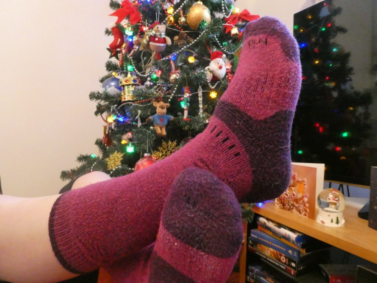 A pair of pink and purple hiking socks. I'm actually lying on my back off camera, holding my crossed feet up.