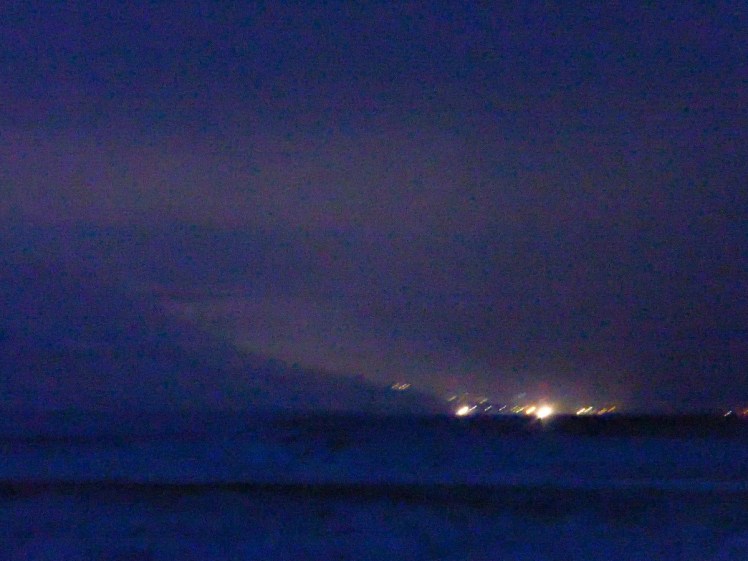 The lights of Longyearbyen glowing in the distance. This is why it's best to get out of town for real darkness for Northern Light hunting.