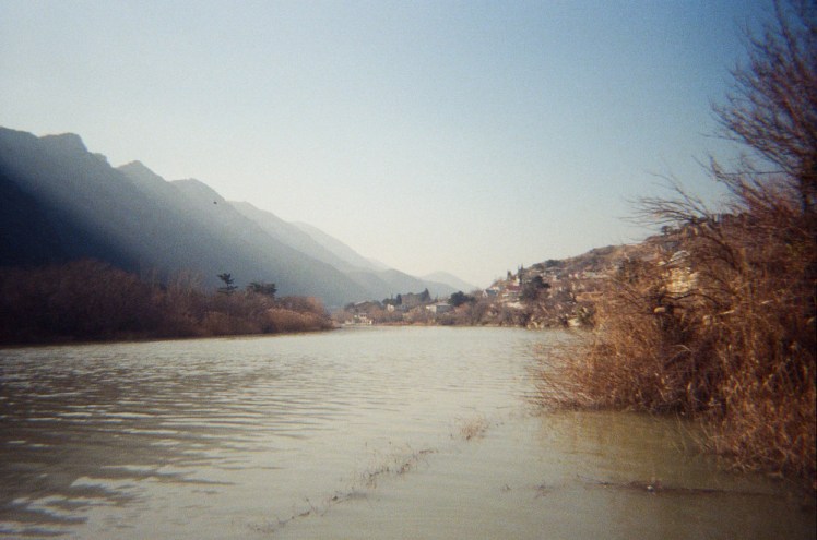 The view down by the river at Mtskheta, with mountains down the right hand side, fading from navy blue to powder blue as they go along.