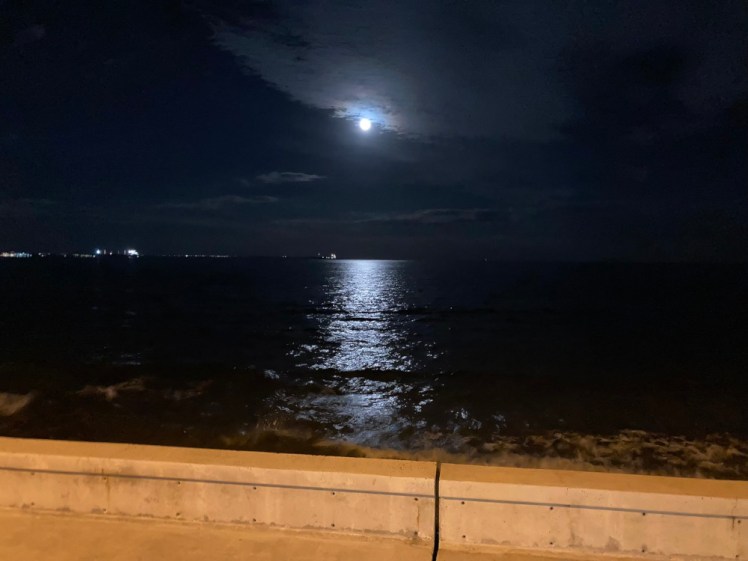 The full moon reflecting over a beautiful Mediterranean and the illuminated prom at Larnaca.