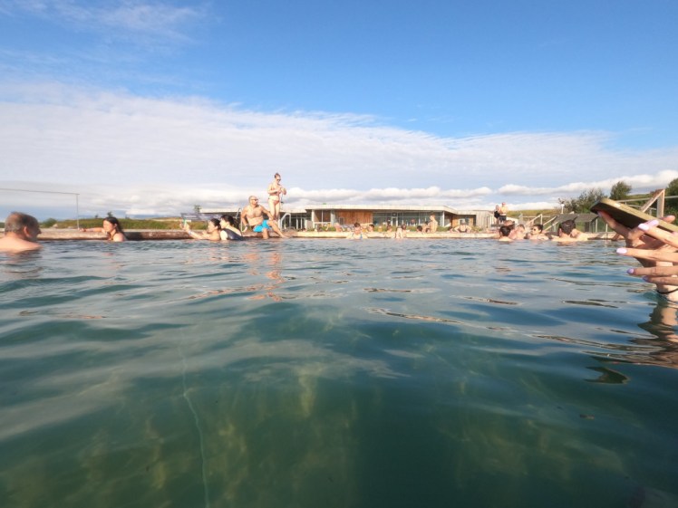 People in the hexagonal infinity pools. You can see how everyone is sitting around the edges and the middle is empty.