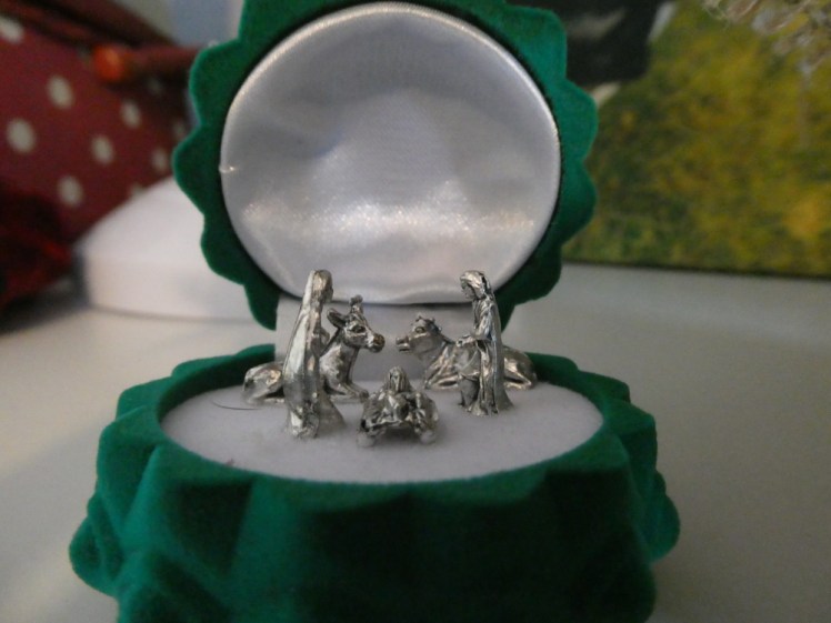 Miniature nativity set inside a hinged Christmas tree hanging decoration