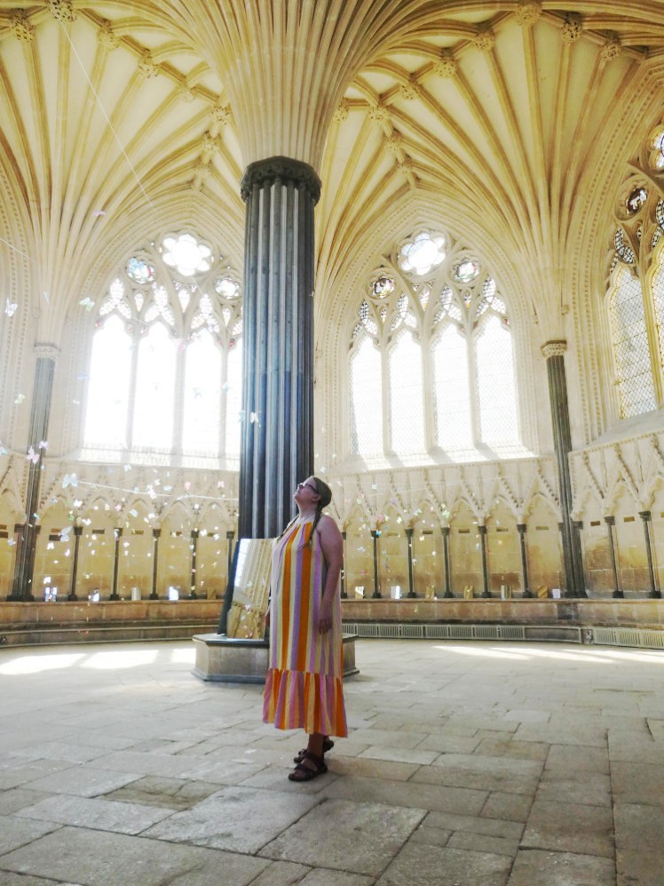 Me in the long candy-striped dress in the chapter house of Wells Cathedral, which is hung with glittery butterflies as part of an art installation.