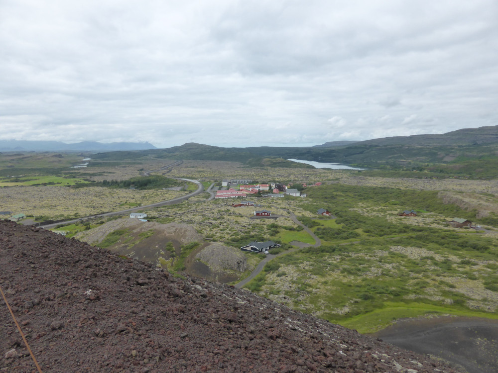 The view over the small town of Bifröst, in the middle of the lava field and the mountains, as seen from the summit of Big Grábrók.
