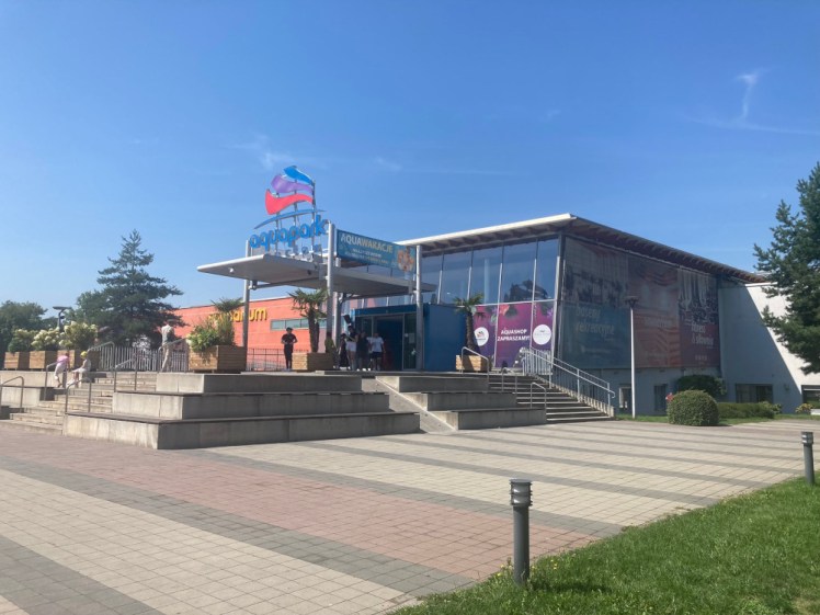 The Aquapark, a large building with a big glass frontage. Behind that, you can see the orange of the side of the building housing the Saunarium. There's a huge pool complex hidden behind all this.