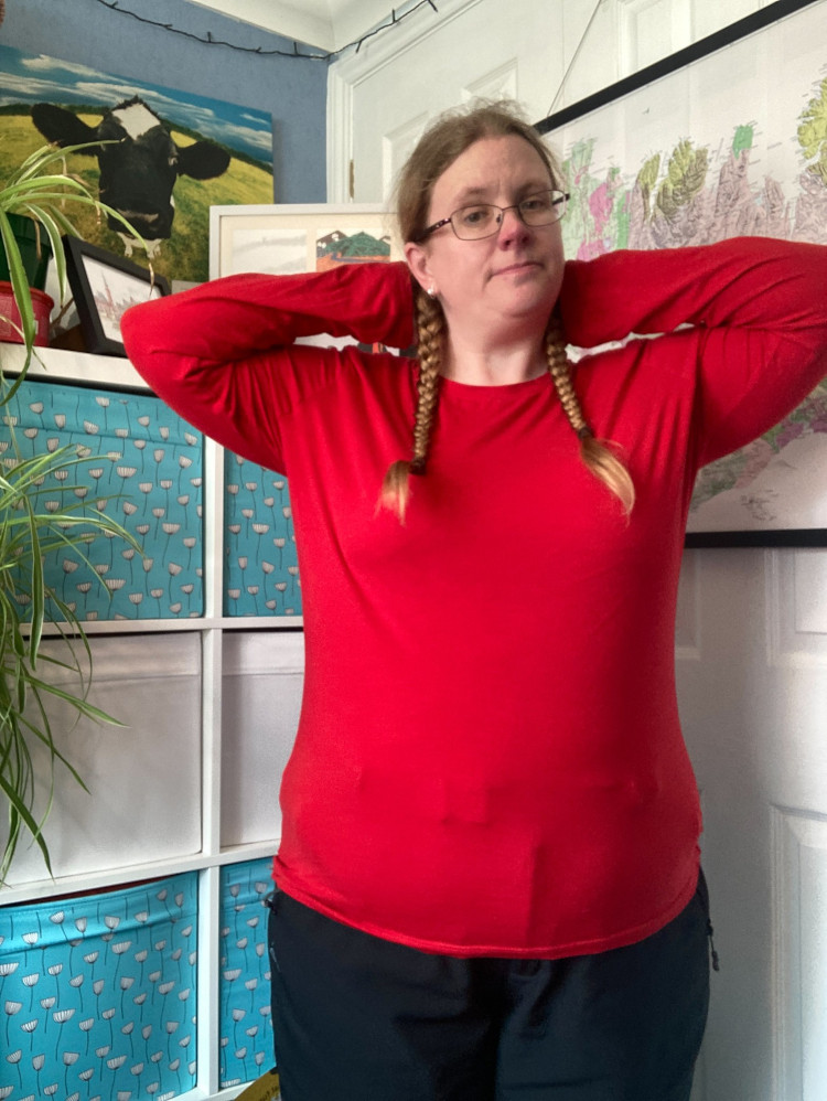 Me in my office wearing a long-sleeved bright red t-shirt top.