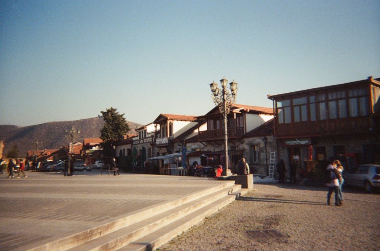 The centre of Mtskheta, with wooden-fronted buildings along the side of a brick square.