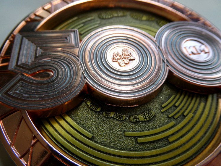 Close-up of the 500km medal in all its gold and copper glory