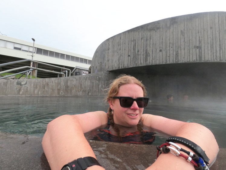 A selfie in Guðlaug Baths - a round concrete pool in the side of a round concrete tower. You can't see the view over the beach and the sea, which is what really sells this place.