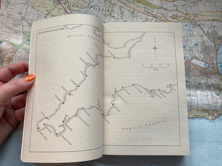 The Salt Path, still lying on top of my Purbeck map but now open to the page with a map of the South West across a double page spread, various locations marked with dots along the 630 mile route.