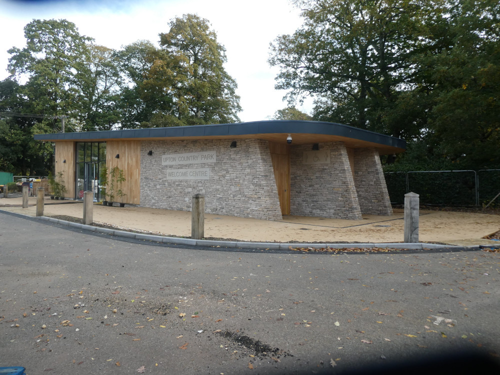 The new visitor centre at Upton Country Park. It's actually still being built. It's a stone and wood building with a slanted flat roof and the name of the place carved into stone blocks in the side.