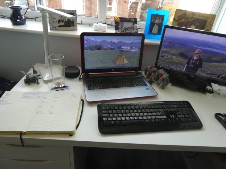 The other end of the desk. Laptop & screen are still visible but now you can see my open diary, my Echo Dot, my lamp, a gargoyle and my drawers.