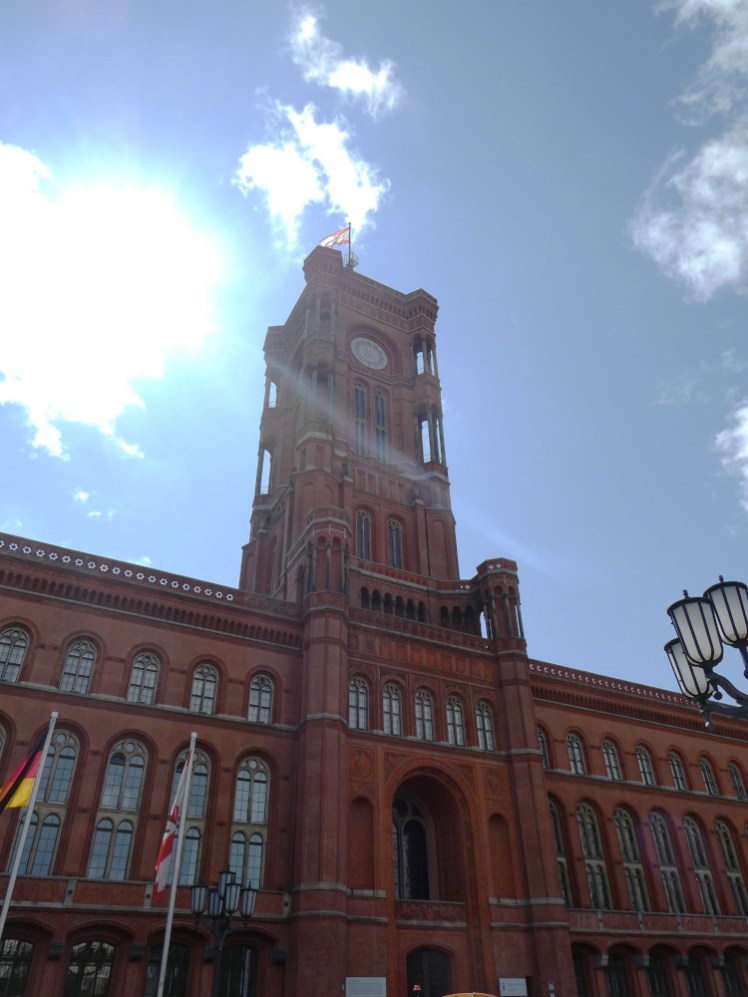 The red brick Red Town Hall, a tower stretching up straight into the midday sun.