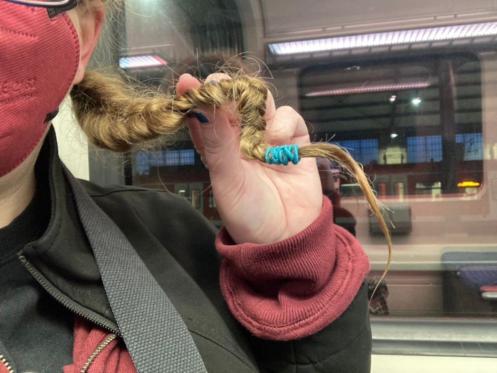 A close-up of one of my plaits on the train. It's bent into two right-angles because it's wet from the thermalbad and has frozen during the long walk back.
