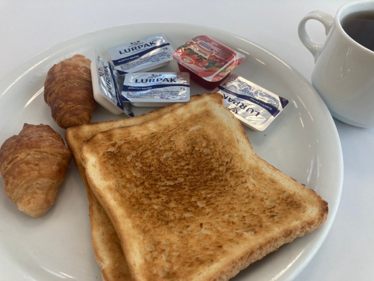 Two slices of perfect toast, two miniature croissants, a few packets of butter, a packet of jam and a mug of apple juice (I know it looks like coffee but it's apple juice).