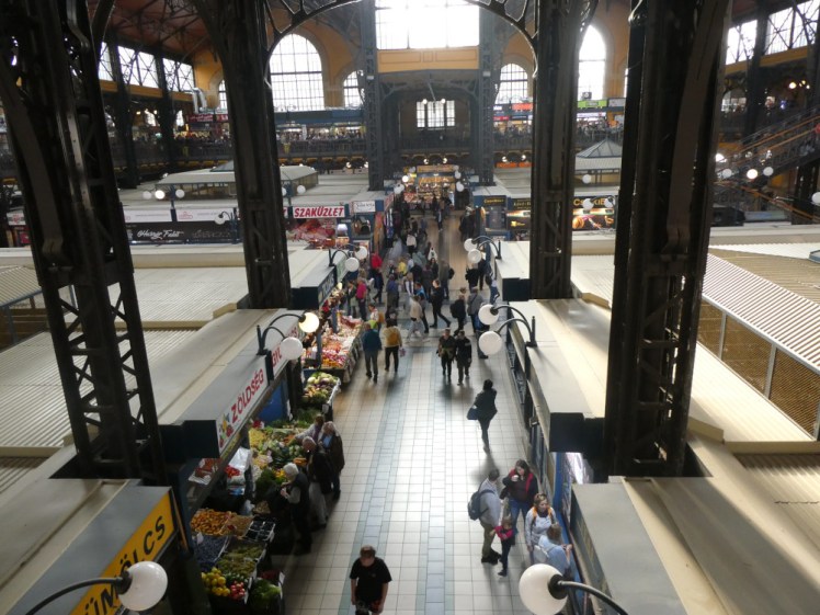 The view from the balcony of a wrought-iron hall filled with a labyrinth of small shops and kiosks.