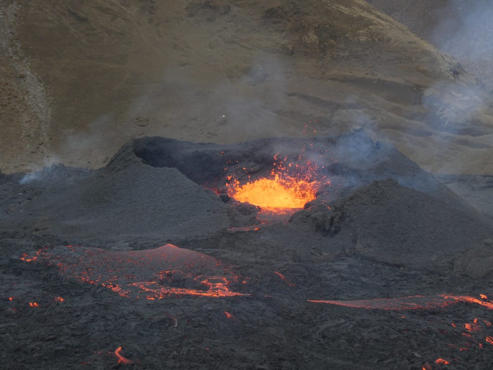 A close-up (taken with a zoom lens) of lava dancing in the crater of a tiny newborn volcano.