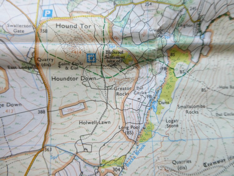 A crinkled bit of map showing Hound Tor and three green dashed lines meeting just below it.