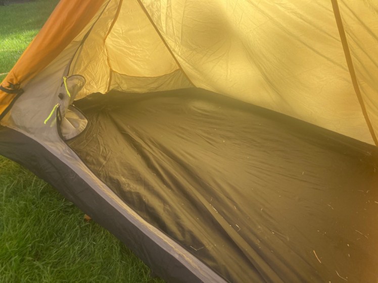 Inside the tent. It has a black floor but the inner is white and it's glowing yellow through the yellow outer in the sun.