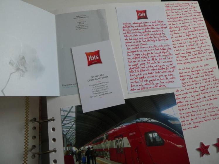 The same page as before but now the hotel card holder is opened to reveal the hotel's business card tucked inside.