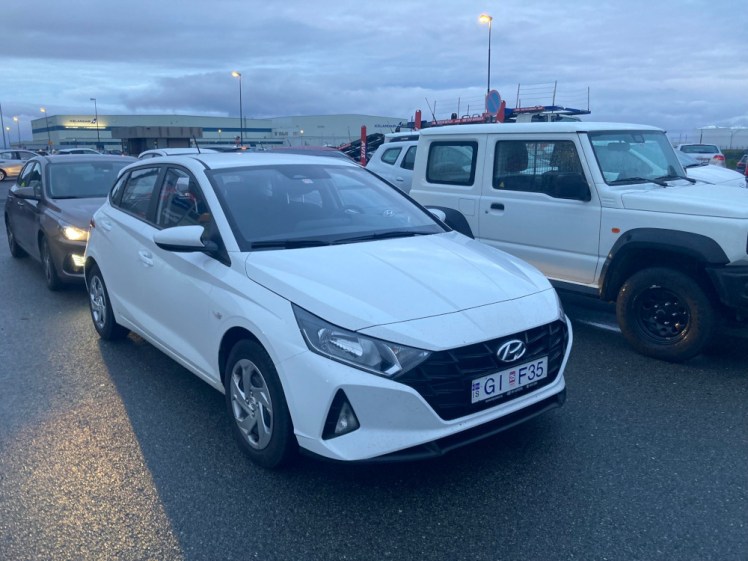 My car being dropped off at 5am. It's not dark exactly but the photo is blue-tinted and you can see the lights around the car park and the car parking behind me.