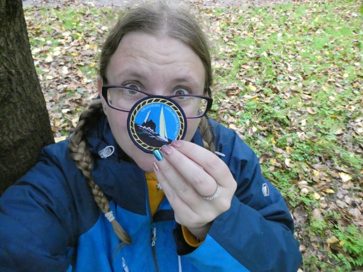 Selfie with my Fastnet Challenge badge in the woods