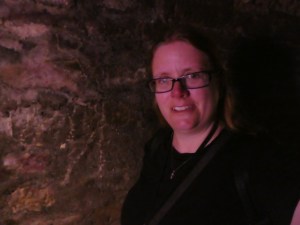A very pink-tinted selfie. I'm down in the Paris Catacombs, taking a selfie lit by one of the sodium lights in the galleries before you reach the ossuary.