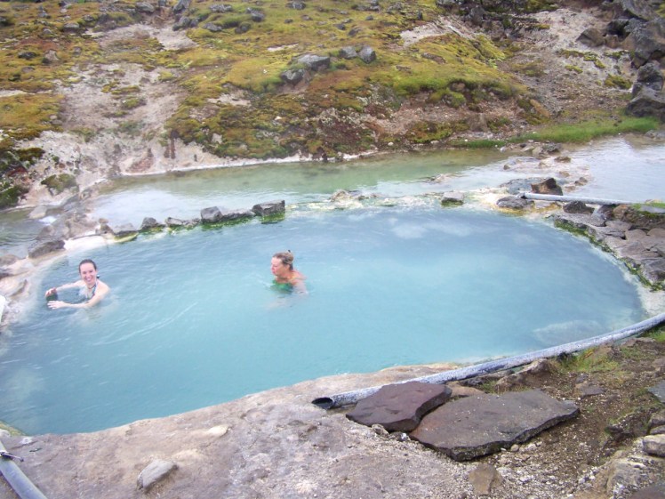 Some people in the pool dug out at the hot spring at Hveravellir, as seen from a tour bus crossing the Kjölur route back in 2013.