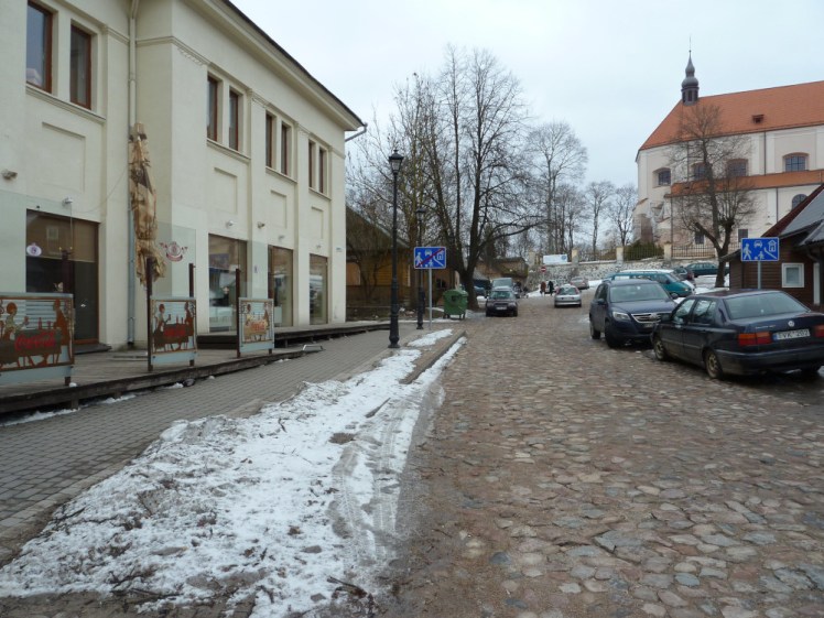 A cobbled street in Trakai, with slightly more modern-looking buildings along the sides than in the previous picture. It's pretty deserted.