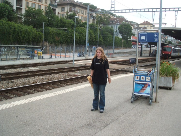 Me during my year abroad, standing on the platform at Neuchatel station clutching a baguette.
