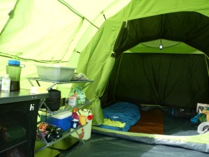 The interior of the Sendero 4, showing the dark bedroom compartment and the large porch with my kitchen shelf unit set up.