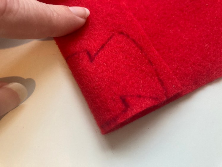 The felt folded over and the robe drawn onto it so that the neck and shoulders are on the fold.