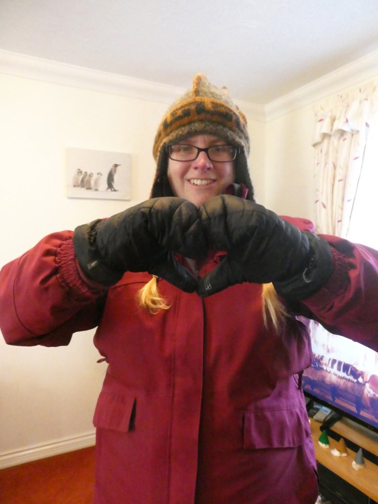 I'm still in the same outfit but now I'm wearing thick padded black mittens and trying to make the heart hands with them.