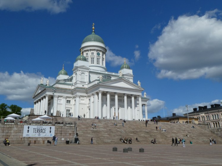 Helsinki Cathedral, a white Neoclassical cathedral with green domes in each corner and the top.