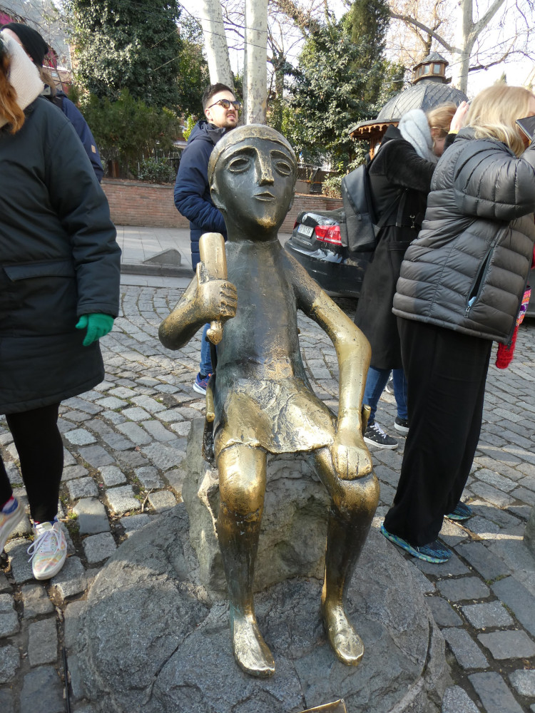 A bronze statue about four feet high, of the tamada holding a horn of ...