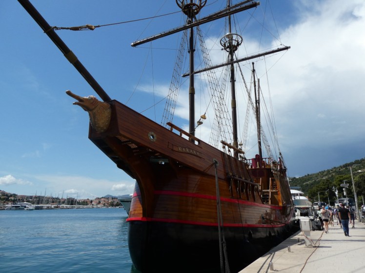 A very shiny three-masted carrack sailing ship moored in Dubrovnik's new port.