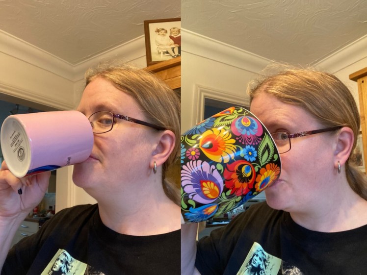 Me pretending to drink from a normal mug and me pretending to drink from the Polish mug, which covers most of my face and is covered in colourful flowers on a black background.