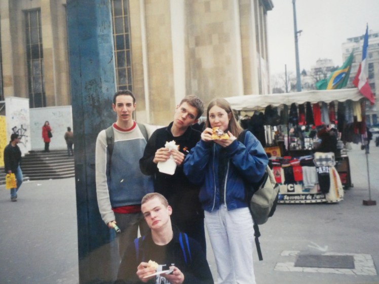 My friends Andy, Chris, Catherine and David (on the floor) all in early-00s holiday-wear, eating waffles and posing for the camera at the Trocadero in Paris.