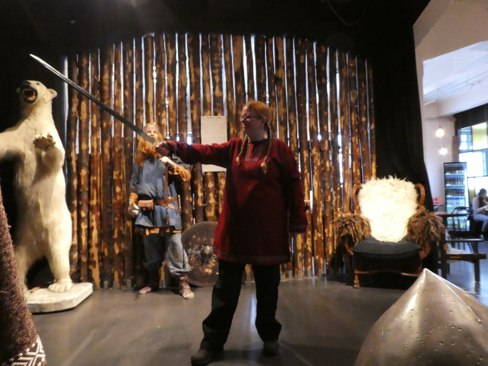 Dressing up at the Saga Museum. I'm wearing a red Viking tunic and waving a large sword.