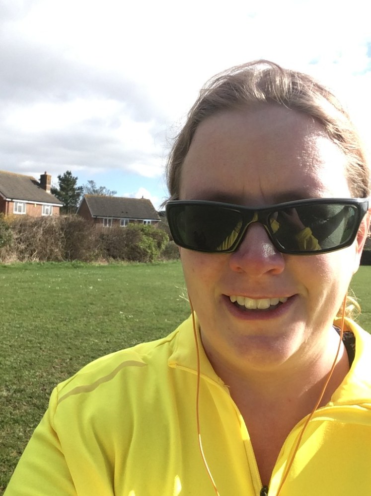 Running selfie - sunglasses, orange earphones and bright yellow running top