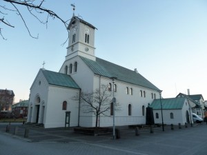 Reykjavik Cathedral, an unimposing small white church with green roofs.
