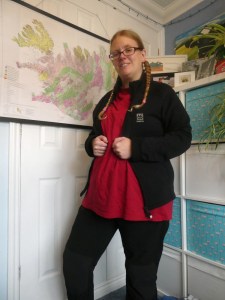 Now I'm wearing a large red t-shirt. Over it is another black jacket, this one open, although I'm holding it by the zip. It's very simple, with no pockets or hoods or weird insert.