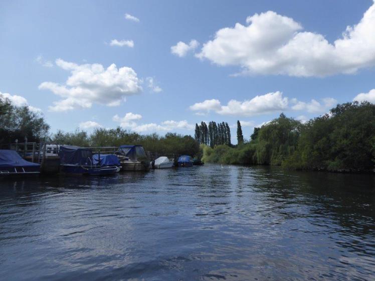 Boats moored along the left side of the River Frome