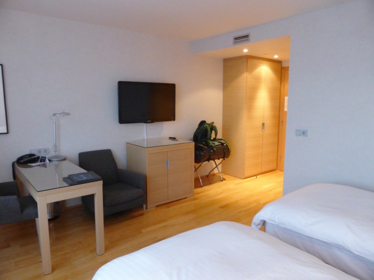 My room in the Hilton Reykjavik. It's the cheapest room but it's noticeably shinier than the guesthouse room. The wooden floor is shiny, there are two immaculate beds, spotlights in the ceiling and pale wood desk and cupboard.