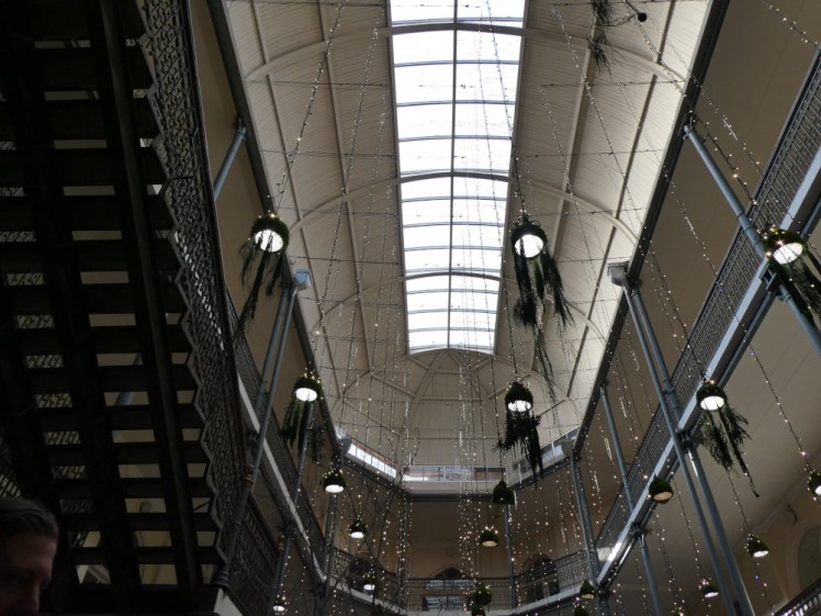 Inside the Caravanserai, a long oval building that used to be open in the roof, with balconies running around and open metal decorative stairs going up. These days there are decorative string lights hanging down from the ceiling.