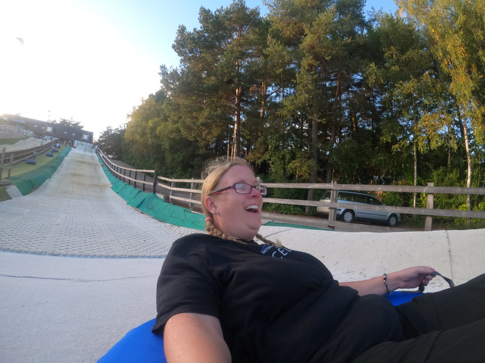 A selfie with the characteristic distortion of a GoPro. I'm at the bottom of the hill, learning back in my ringo, laughing in delight and terror.