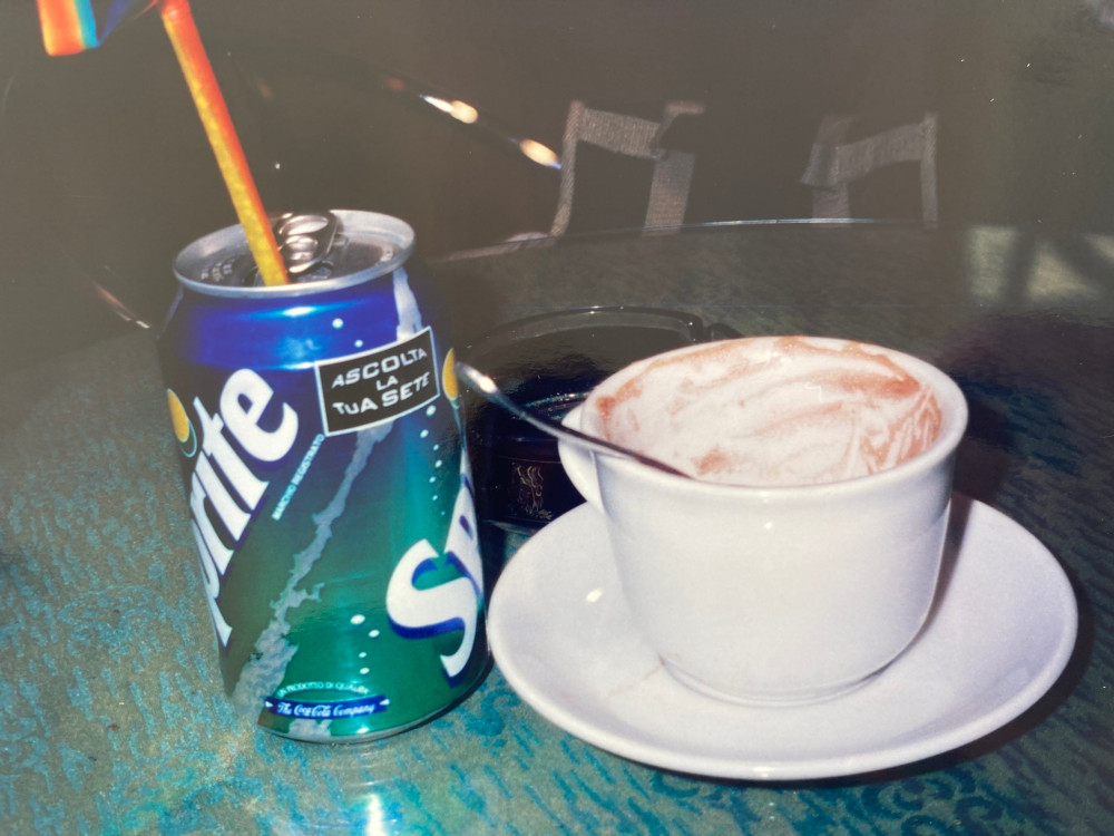 Our drinks in the cafe in Messina - a can of Sprite with a rainbow straw sticking out of it and an empty cup of hot chocolate.