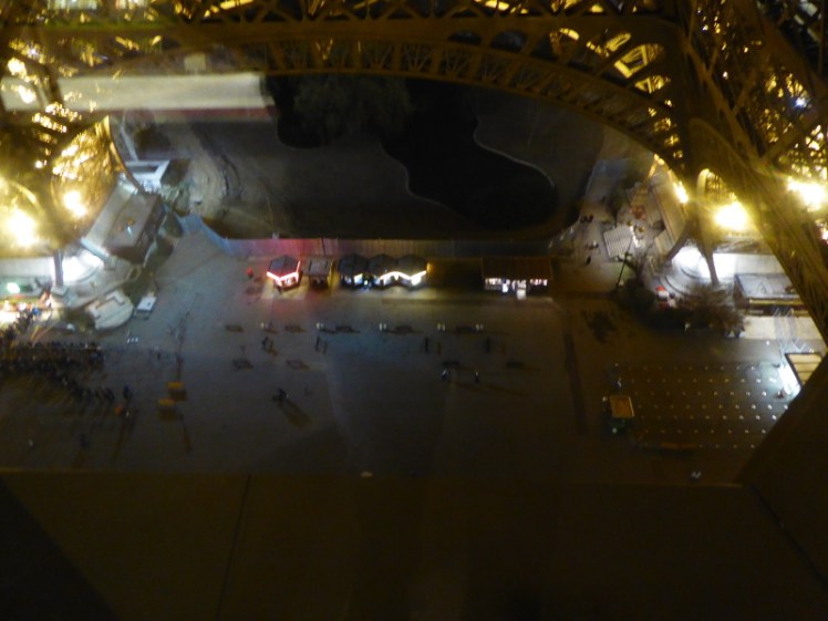 Looking straight down the glass floor of the Eiffel Tower