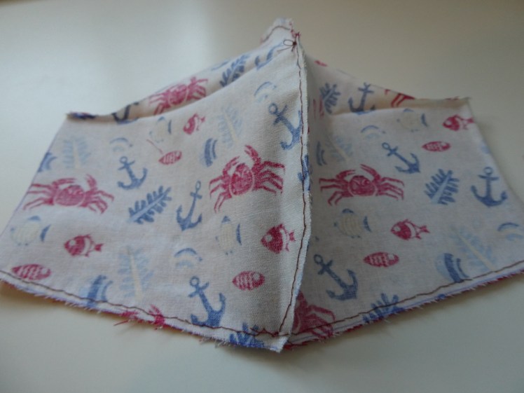 Two mask pieces sewn together along the long bottom seam